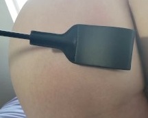 Yvonne's riding crop impacts on a man's bare buttock
